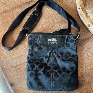 Womens black Coach crossbody bag.